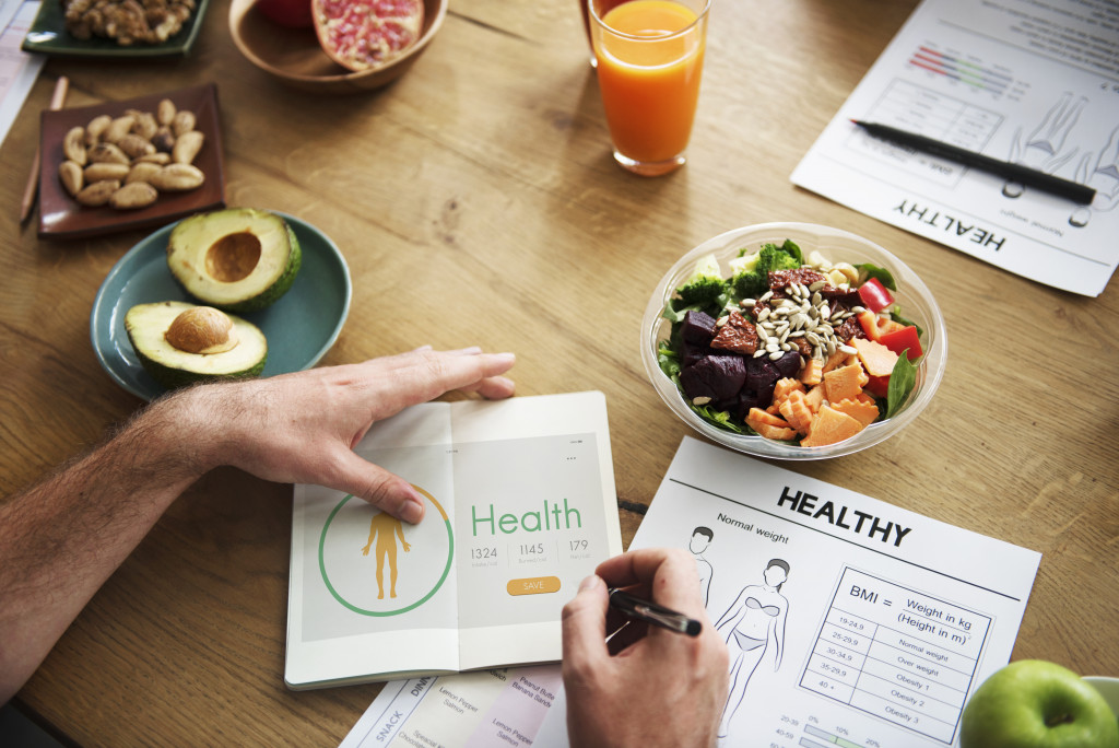 person with healthy food and health checklist