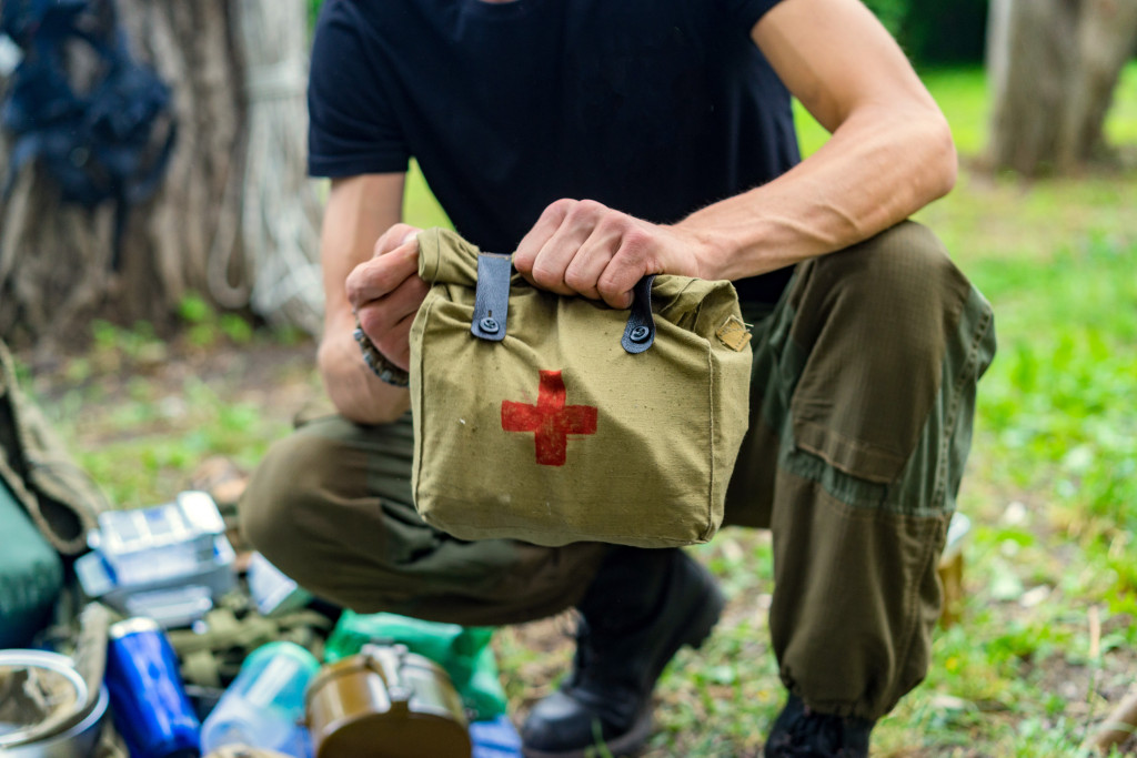 Focus on camper's hands holding a first aid kit