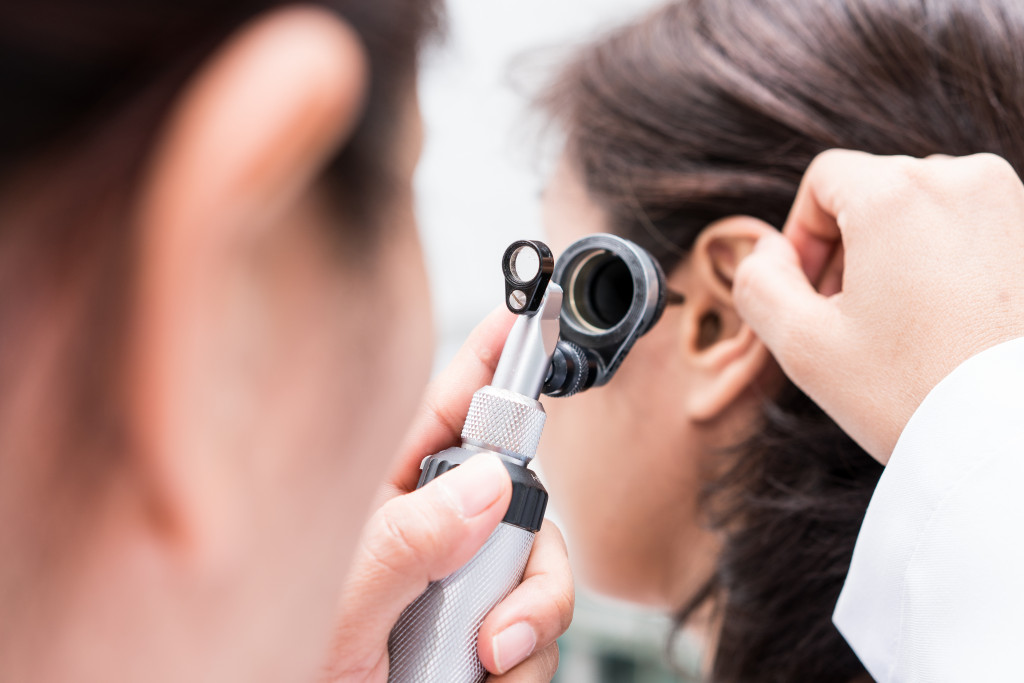 woman getting checked by an audiologist