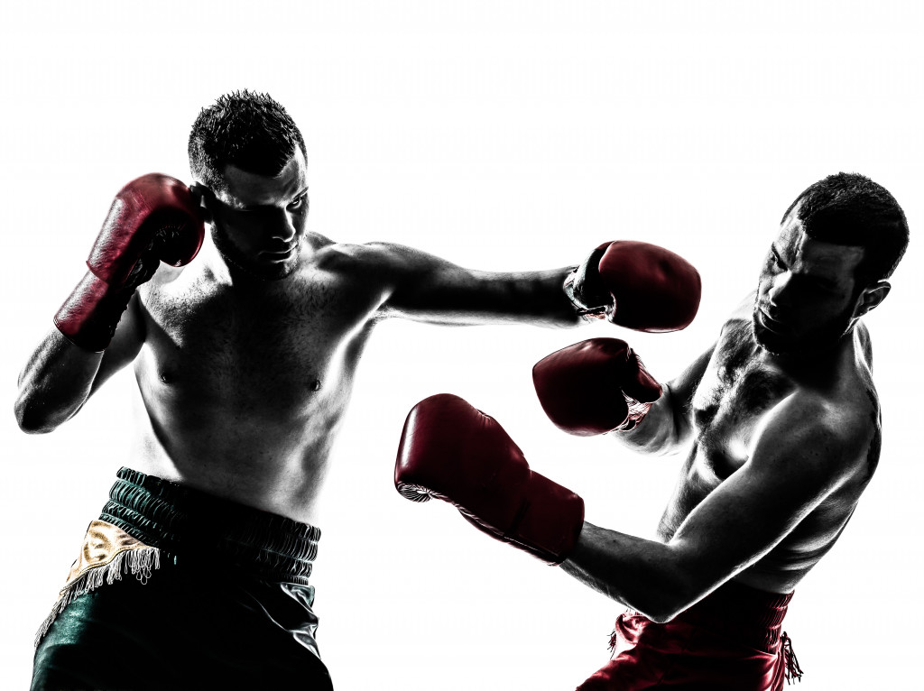 Two men boxing in front of a white background