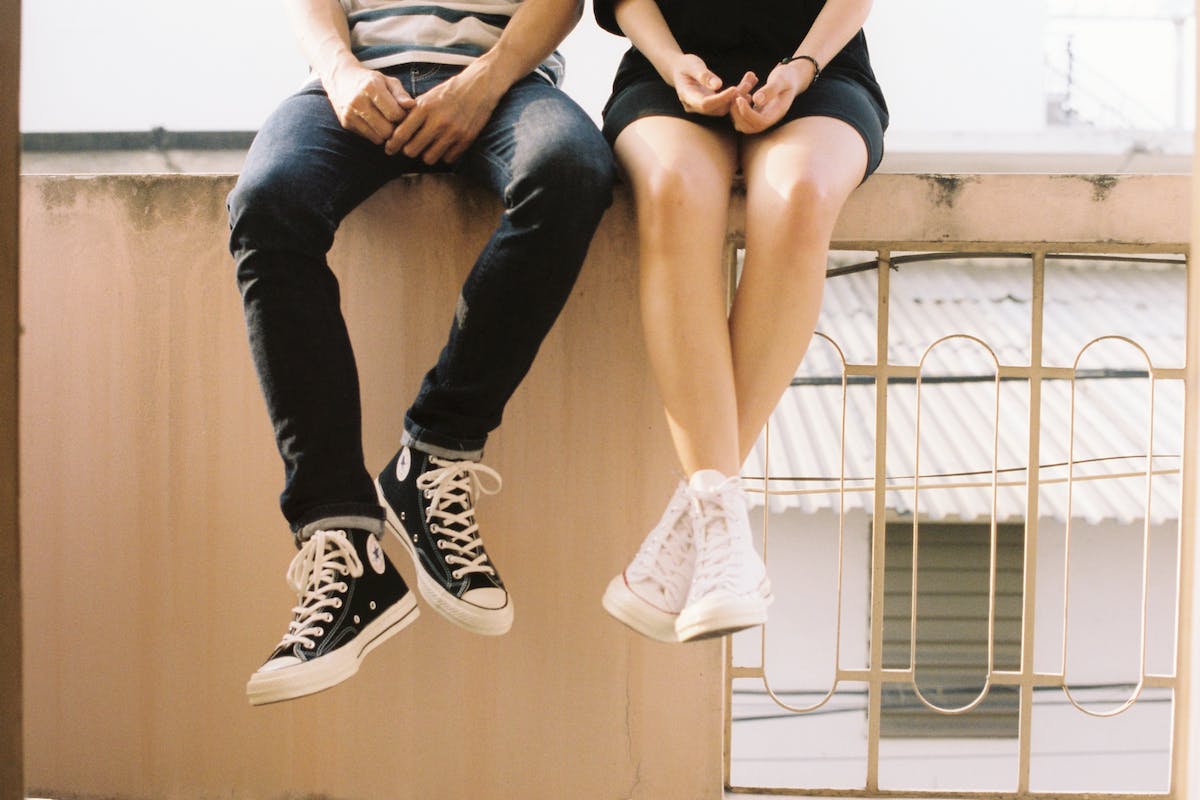 couple sitting on a suspended beam