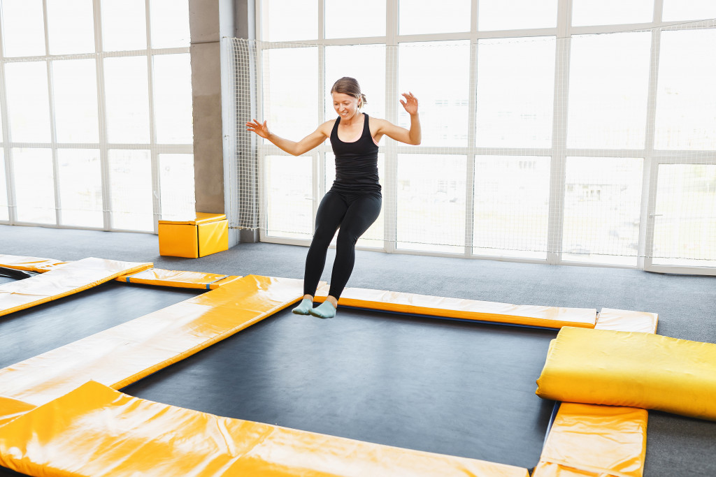 a woman jumpingon the trampoline