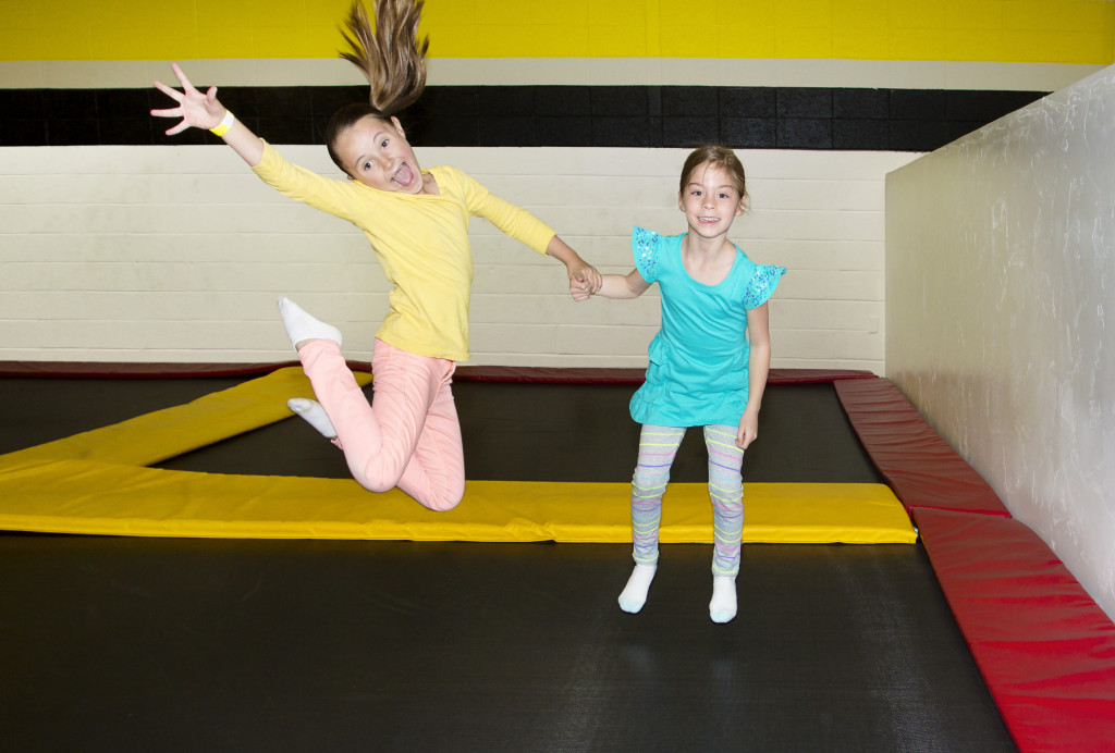 kids jumping at a trampoline