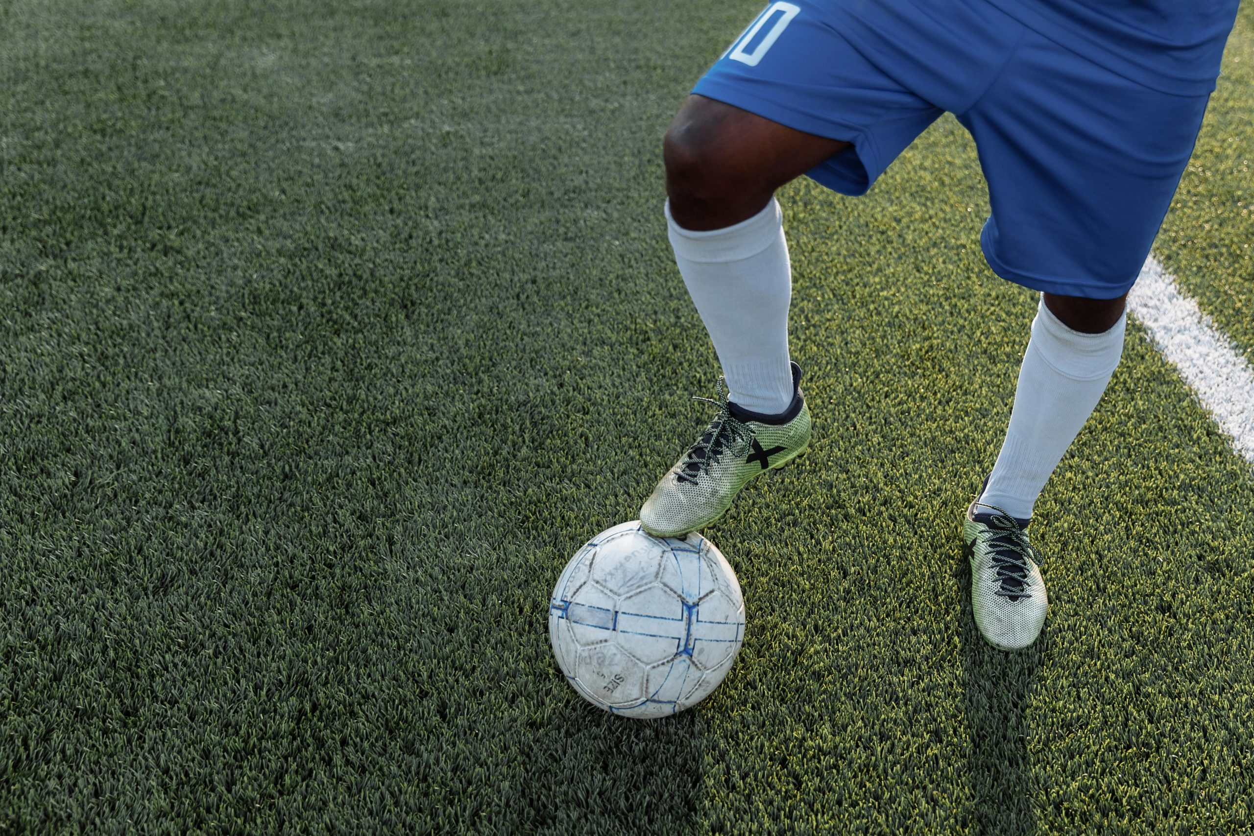soccer player's foot on a soccer ball